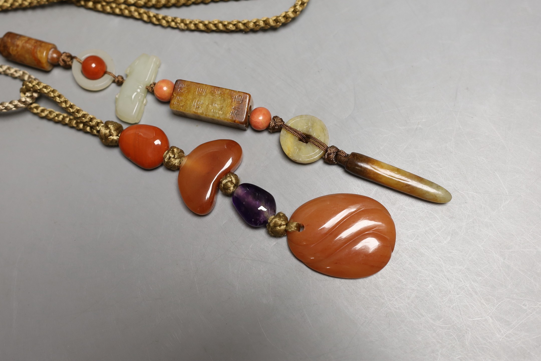 Kai Yin Lo, Hong Kong, A jade and coral mounted necklace and an agate and amethyst mounted necklace